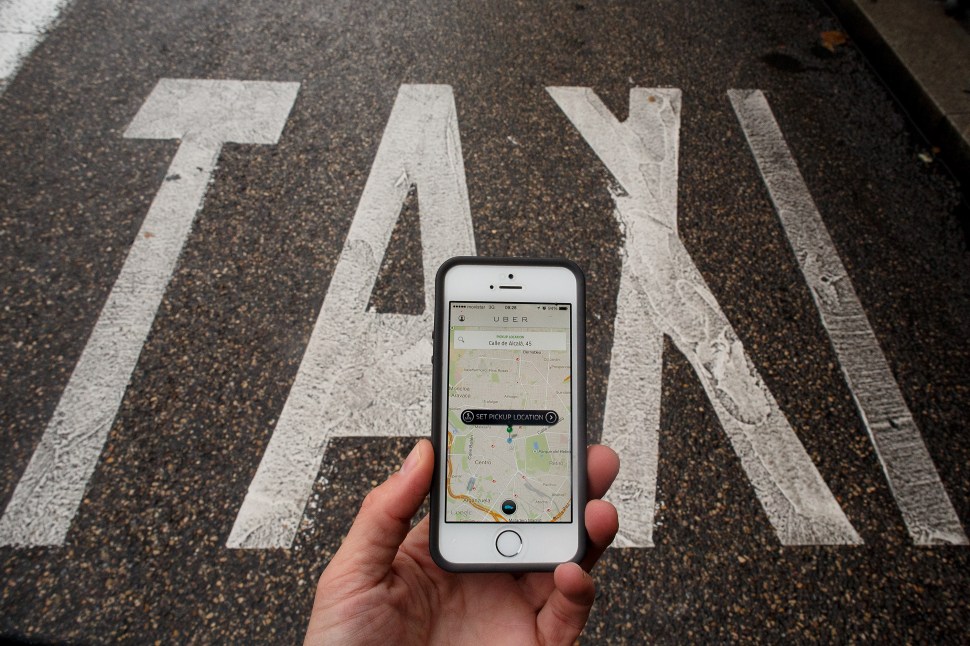 In this photo illustration the smart phone taxi app 'Uber' shows how to select a pick up location next to a taxi lane on October 14, 2014 in Madrid, Spain. (Pablo Blazquez Dominguez/Getty Images)