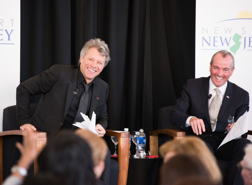 A couple ordinary middle class guys. Jon Bon Jovi (L) and Philip Murphy speak at the Middle Class Advocacy Group Summit on November 10, 2014 in Newark.  (Dave Kotinsky/Getty Images)