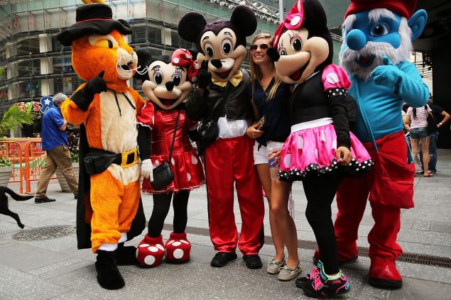 Costumed street performers pose with tourists for tips in Times Square on July 28, 2014 in New York City. (Photo: Spencer Platt/Getty Images)