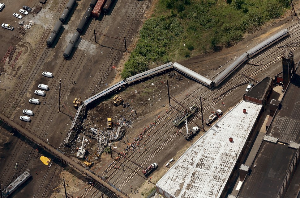 Investigators and first responders work near the wreckage of Amtrak Northeast Regional Train 188, from Washington to New York, that derailed yesterday May 13, 2015 in north Philadelphia, Pennsylvania. At least six people were killed and more than 200 others were injured in the crash.  (Photo: Win McNamee/Getty Images)