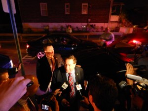 Sacco speaks with reporters outside 90 Palisades. 