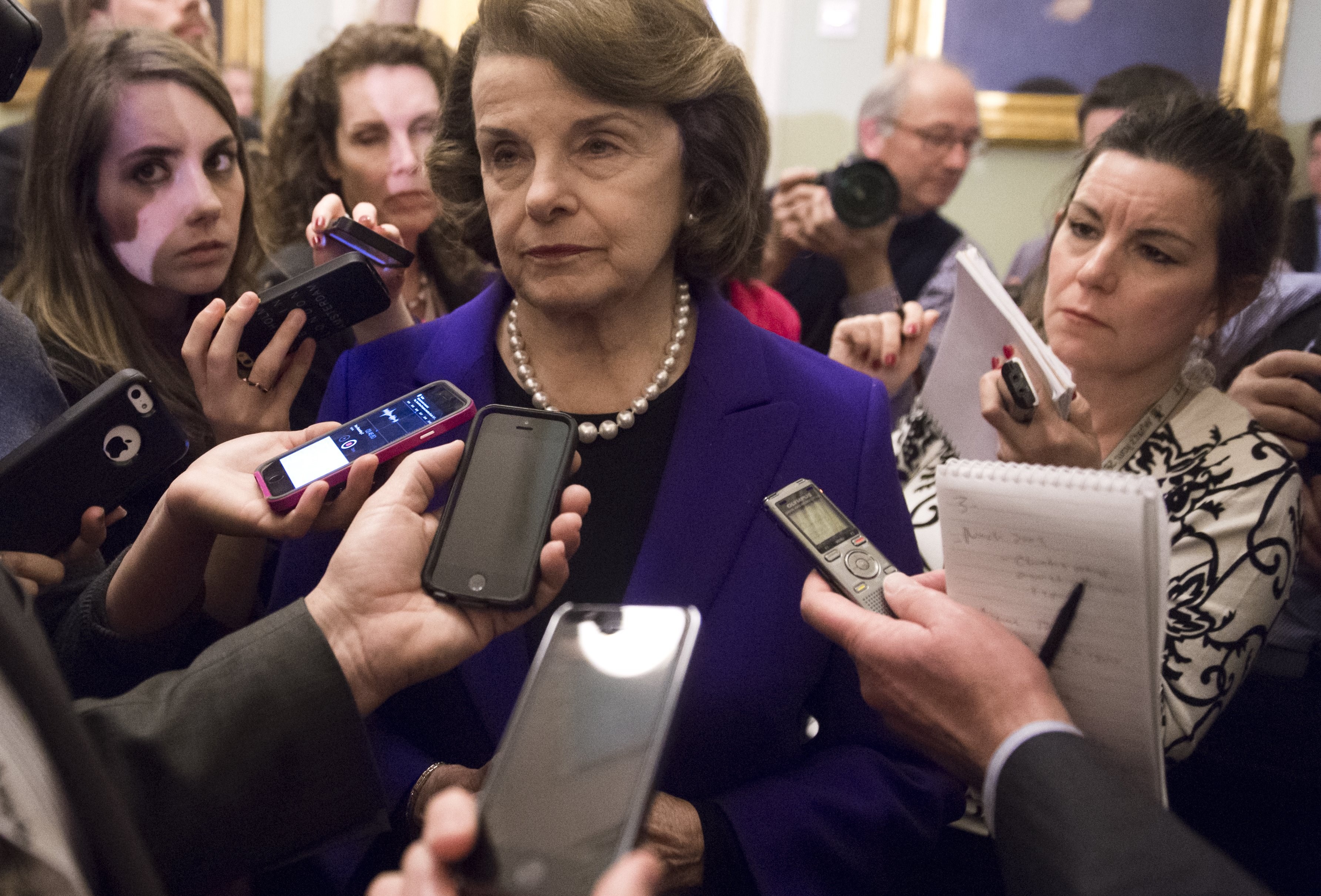 Senate Intelligence Chairwoman Dianne Feinstein (C), a Democrat from California, speaks to reporters about the committee's report on CIA interrogations at the US Capitol in Washington, DC, December 9, 2014.  The CIA's interrogation of Al-Qaeda suspects was far more brutal than acknowledged and did not produce useful intelligence, a damning and long-delayed US Senate report said Tuesday. The Central Intelligence Agency also misled the White House and Congress with inaccurate claims about the program's usefulness in thwarting attacks, the Senate Intelligence Committee said. AFP PHOTO / SAUL LOEB        (Photo credit should read SAUL LOEB/AFP/Getty Images)