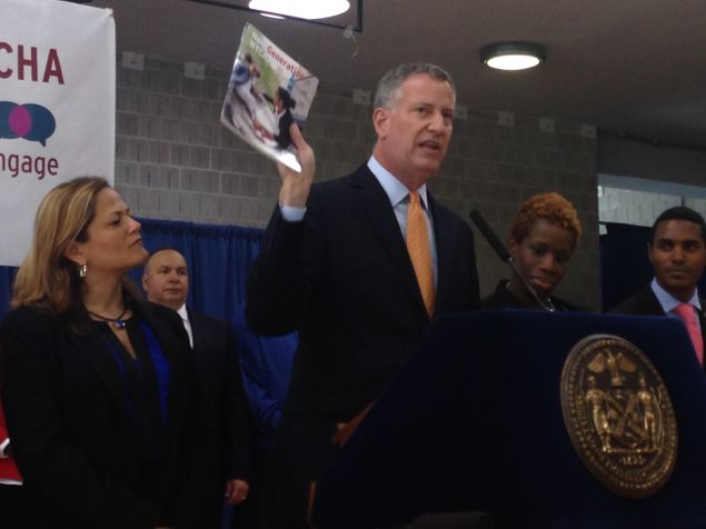 Mayor Bill de Blasio holds up the NextGeneration NYCHA plan (Photo: Will Bredderman for Observer).