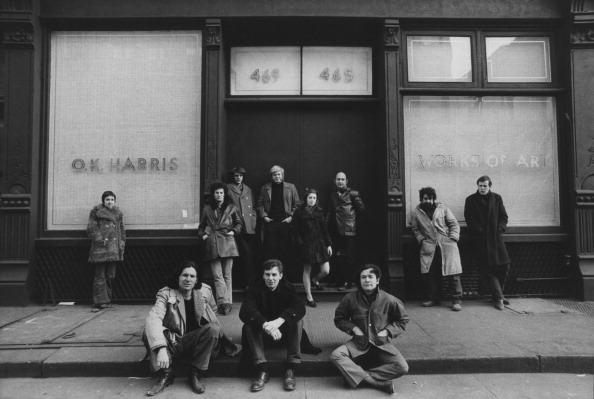 Art dealer and Director of OK Harris Gallery Ivan Karp poses with OK Harris artists for a portrait in February 1970 in front of OK Harris Gallery in Soho, New York City, New York. In the doorway, starting second from left is artist Duane Hanson, Ms. Marilyn Karp, and gallerist Ivan Karp. (Photo by David Gahr/Getty Images)
