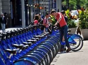 With AFP Story by Brigitte DUSSEAU: US-Transport-Bicycle-Share-CitiBike A couple get their Citi Bike bicycles from a station near Union Square as the bike sharing system is launched May 27, 2013 in New York. About 330 stations in Manhattan and Brooklyn will have thousands of bicycles for rent. AFP PHOTO/Stan HONDA        (Photo credit should read STAN HONDA/AFP/Getty Images)