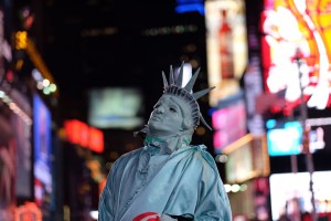 A man dressed up like the Statue of Liberty in Times Square, New York (Photo by JEWEL SAMAD/AFP/Getty Images)