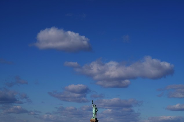 The Statue of Liberty is pictured from a passenger ferry in New York (Photo by JEWEL SAMAD/AFP/Getty Images)