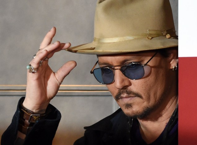 US actor Johnny Depp gestures during his photo call in Tokyo on January 28 2015.  Depp attended the Japan premiere of his latest action comedy movie "Mortdecai" on January 27 which will be screened in Japan from February 6.    AFP PHOTO / TOSHIFUMI KITAMURA        (Photo credit should read TOSHIFUMI KITAMURA/AFP/Getty Images)