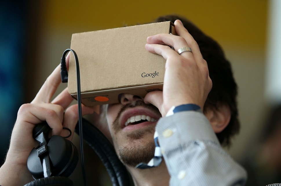 SAN FRANCISCO, CA - MAY 28: An attendee inspects Google Cardboard during the 2015 Google I/O conference on May 28, 2015 in San Francisco, California. The annual Google I/O conference runs through May 29.