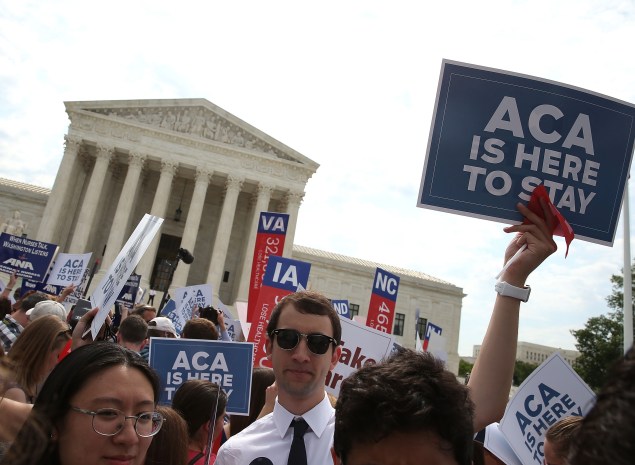 WASHINGTON, DC - JUNE 25: People celebrate in front of the US Supreme Court after ruling was announced on the Affordable Care Act. June 25, 2015 in Washington, DC. The high court ruled that the Affordable Care Act may provide nationwide tax subsidies to help poor and middle-class people buy health insurance. (Photo by Mark Wilson/Getty Images)
