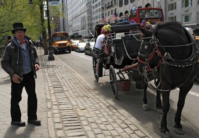  A horse drawn carriage driver waits for customers outside of Central Park. (Photo: Spencer Platt for Getty Images)