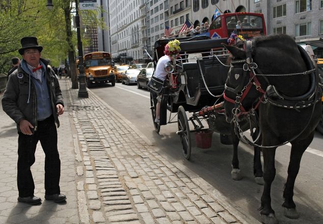 A horse drawn carriage driver waits for customers outside of Central Park. (Photo: Spencer Platt for Getty Images)