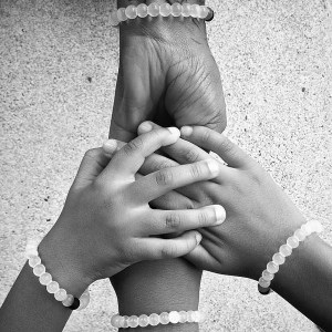Hands wearing classic Lokai bracelets