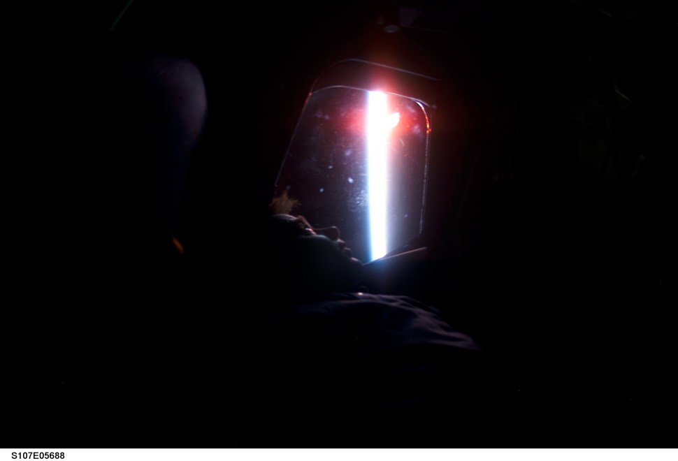 STS107-E-05688 (26 January 2003) --- Ilan Ramon, STS-107 payload specialist, looks at Earth’s horizon through a window of the Space Shuttle Columbia. Ramon represents the Israeli Space Agency.