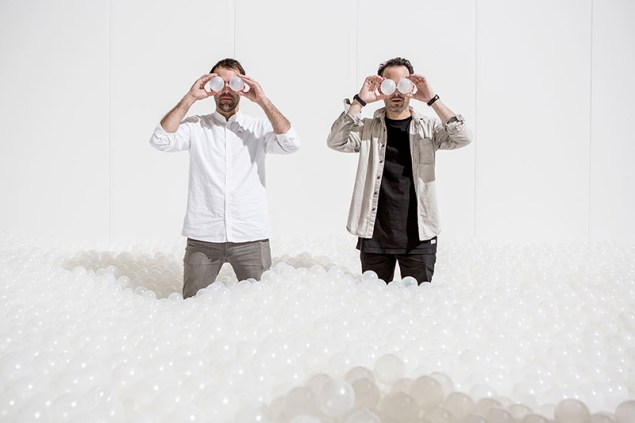 Alex Mustonen and Daniel Arsham of Snarkitecture, somewhat ironically holding plastic balls from their installation The BEACH up to their eyes. (Photo: Courtesy of Snarkitecture)