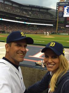 Jim and Sarah Harbaugh wearing maize and blue Tigers hats. (Twitter/@coachjim4um )