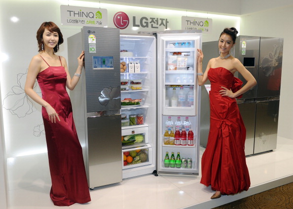 South Korean models pose with an LG Electronics refrigerator connected to a home Wi-Fi network and can be controlled by a smartphone, during a launching event in Seoul on April 19, 2011. South Korea's LG Electronics unveiled a refrigerator which suggests recipes as it forecast a bright future in the potentially lucrative market for "smart" household appliances.   AFP PHOTO/JUNG YEON-JE 
