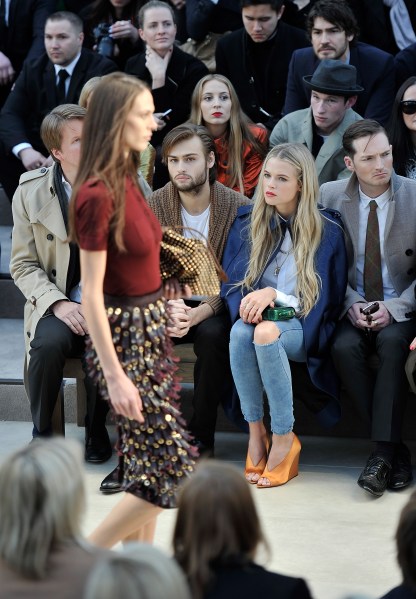 LONDON, UK - FEBRUARY 18: (LR) Tom Hooper, Douglas Booth and Gabriella Wilde in the front row at the Burberry Prorsum Fall/Winter 2013 womenswear show in London, UK on February 18, 2013. (Gareth Cattermole/Getty for Burberry) Photo by Images)