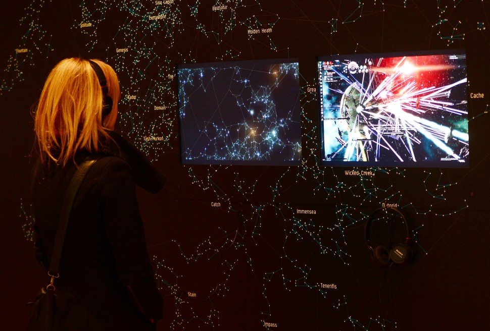 A visitor looks at a demonstration of the video game EVE Online (2003) during an exhibition preview featuring 14 video games acquired by The Museum of Modern Art (MoMA) in New York, March 1, 2013. The MoMA acquired 14 video games entering its collection as part of an ongoing research on interaction design. AFP PHOTO/EMMANUEL DUNAND (Photo credit should read EMMANUEL DUNAND/AFP/Getty Images)