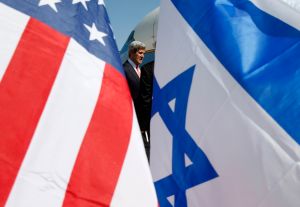 US Secretary of State John Kerry is seen between American (L) and Israeli flags as he arrives in Tel Aviv on May 23, 2013, as he keeps up a push to bring Israelis and Palestinians back to peace negotiations amid a growing scepticism over his efforts. (Photo: JIM YOUNG/AFP/Getty Images)