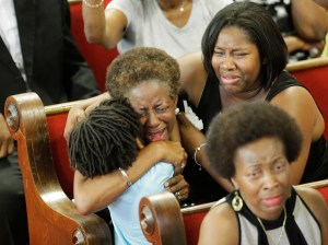 CHARLESTON, SC - JUNE 21:  Parishioners embrace as they attend the first church service four days after a mass shooting that claimed the lives of nine people at the historic Emanuel African Methodist Church June 21, 2015 in Charleston, South Carolina. Chruch elders decided to hold the regularly scheduled Sunday school and worship service as they continue to grieve the shooting death of nine of its members including its pastor earlier this week.  (Photo by David Goldman-Pool/Getty Images)