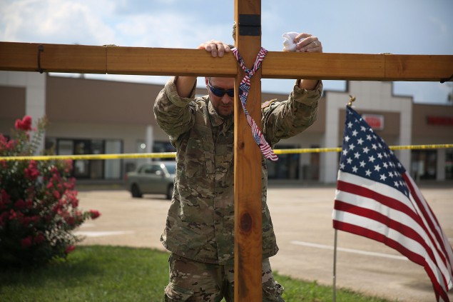 CHATTANOOGA, TN - JULY 18:  Ronald May prays as he supports a cross at a memorial setup in front of the Armed Forces Career Center/National Guard Recruitment Office which had been shot up on July 18, 2015 in Chattanooga, Tennessee. According to reports, Mohammod Youssuf Abdulazeez, 24, opened fire on the military recruiting station on July 16th at the strip mall and then drove to an operational support center operated by the U.S. Navy and killed four United States Marines there and a Navy sailor.  (Photo by Joe Raedle/Getty Images)