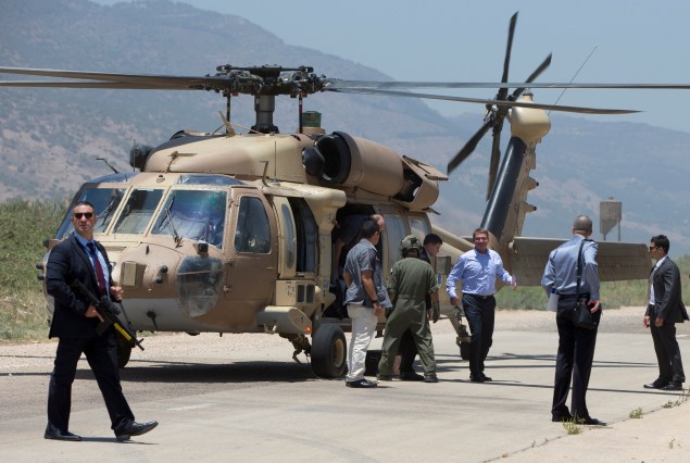 U.S. Defense Secretary Ash Carter, third from right, and Israeli Defense Minister Moshe Ya'alon arrive on a UH-60 Blackhawk helicopter at a Hula Valley landing zone near Yesod Hamala, Israel, Monday, July 20, 2015, in norther Israel near the Lebanon boarder, en route to view the Hula Valley from the Hussein Lookout. Carter said he has no expectation of persuading Israeli leaders to drop their opposition to the Iran nuclear deal, but will instead emphasize that the accord imposes no limits on what Washington can do to ensure the security of Israel and U.S. Arab allies. (AP Photo/Carolyn Kaster, Pool)
