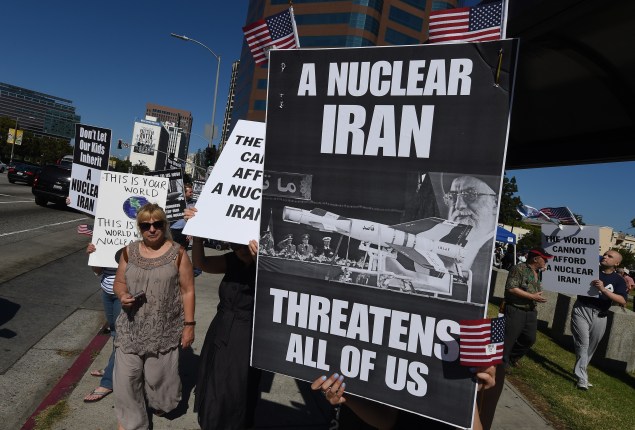 Members of the 'Stand With Us' group hold a rally calling for the rejection of the proposed Iran nuclear deal outside the Federal Building in Los Angeles on July 26, 2015.  White House contender Mike Huckabee is warning that President Barack Obama is marching the Israelis to the "door of the oven" by signing off on the nuclear deal struck between Iran and six world powers. Iran clinched the agreement with Britain, China, France, Germany, Russia and the United States two weeks ago. AFP PHOTO/MARK RALSTON        (Photo credit should read MARK RALSTON/AFP/Getty Images)