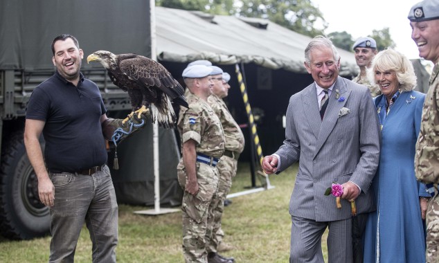 "Please let me stop posing with this bird now" (Photo: Richard Pohle - WPA Pool /Getty Images)