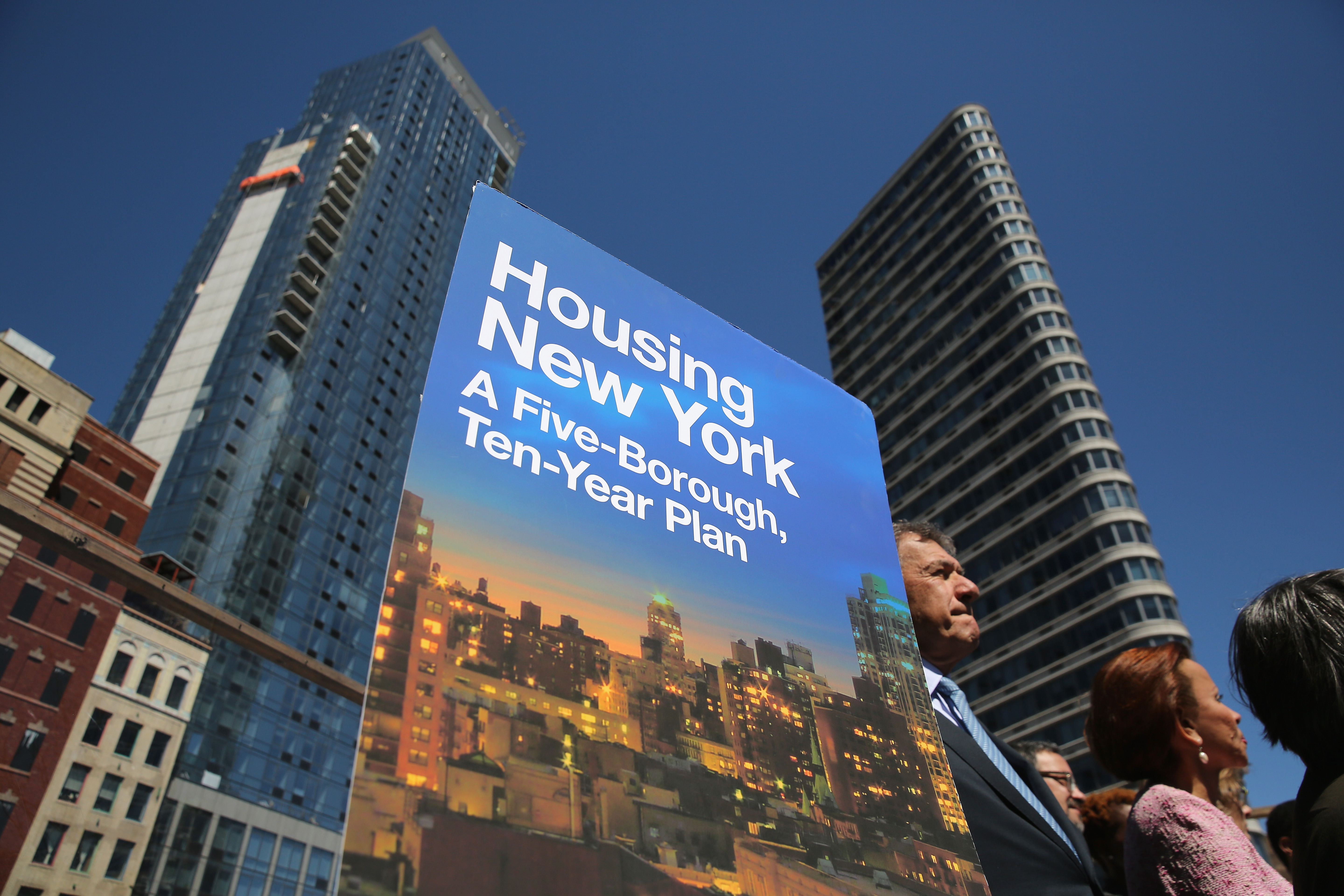 A sign for New York City Mayor Bill de Blasio's new housing plan stands at an affordable housing construction site.