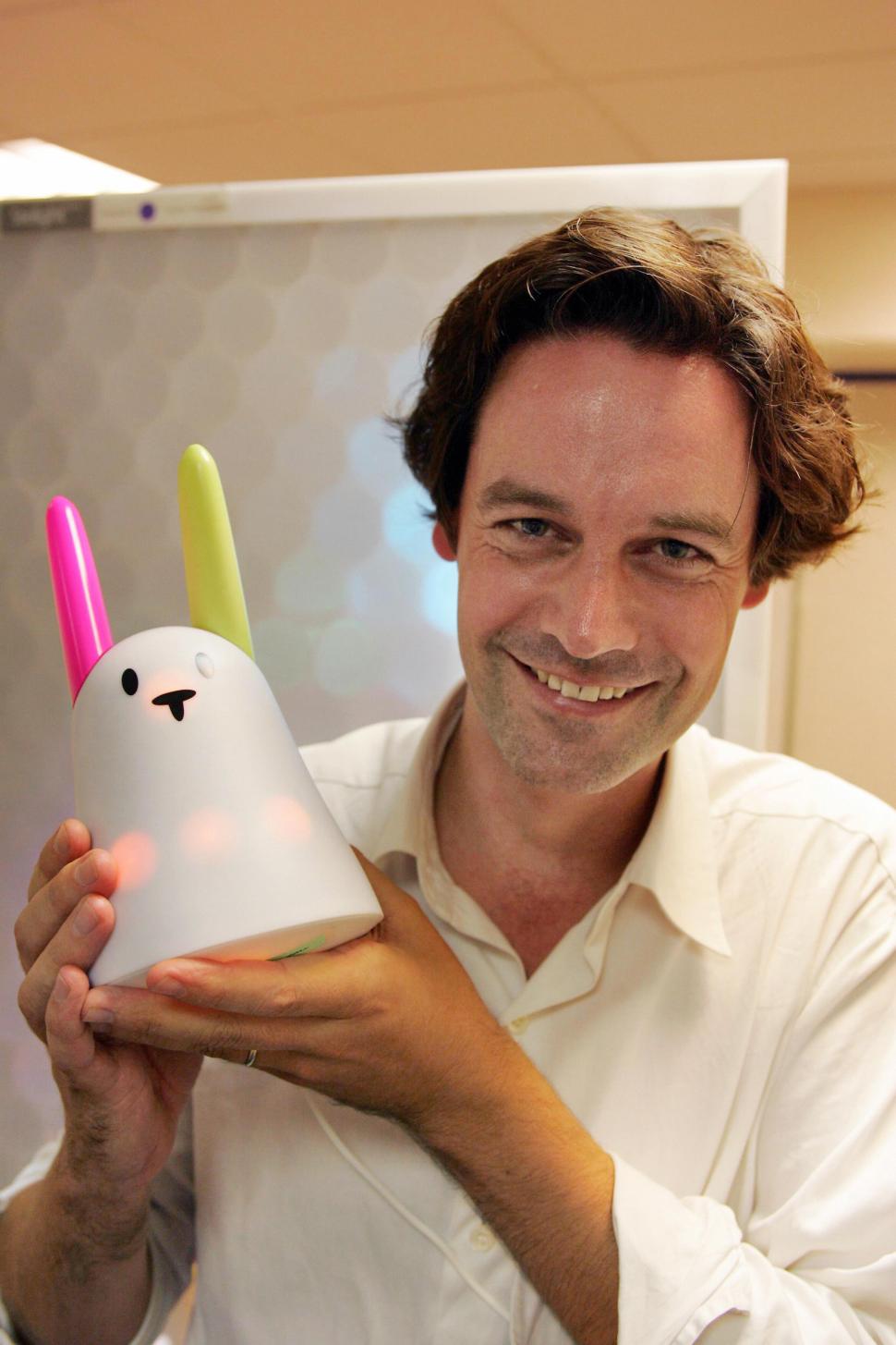 Paris, FRANCE: Olivier Mevel, head of Violet company, poses, 15 September 2005, with a 'Nabaztag' the first ever released wide-audience communicating device. Along with Violet's co-founder Rafi Haladjian, Mevel called the device ' Nabaztag', which means rabbit in Armenian. It may be connected to other Nabaztags through the Internet, using DSL and wireless means, and thus may, among other things, play MP3, warn when emails are delivered and do so even when its owner's computer is not connected, thanks to the www.nabaztag.com website it'll be registered to. AFP PHOTO DAMIEN MEYER