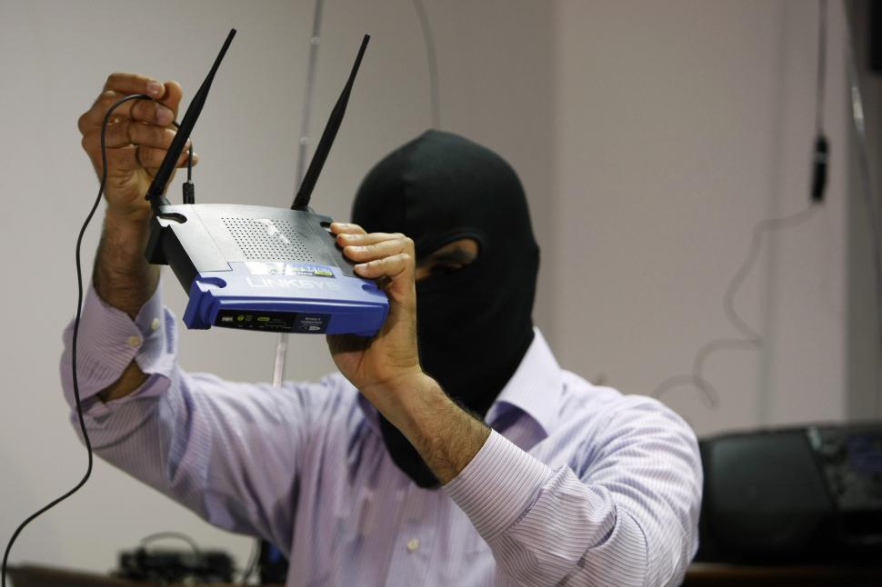 A masked Lebanese secret service officer shows to the media at the Lebanese security services headquarters in Beirut on May 11, 2009 a wireless internet router found with arrested Lebanese nationals accused of spying for Israel. Lebanese authorities have arrested at least 17 suspected spies working for Israel since January. Lebanon and Israel are technically at war and if found guilty the suspected spies could be sentenced to death on charges of high treason. AFP PHOTO/JOSEPH BARRAK 