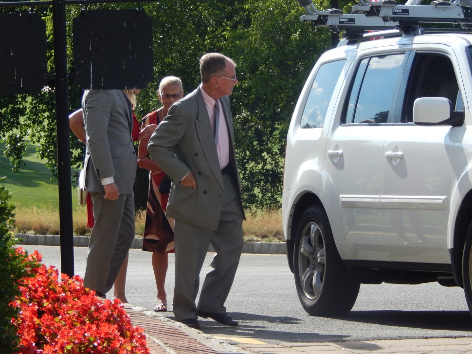Although it looks as though this Jeb Bush reveler (left) arrived to the fundraiser with a lampshade over his head so as not to be recognized by Chris Christie partisans, if you look closely you can see that black, obfuscating object is actually part of the Navesink Country Club grounds, and not a lampshade.