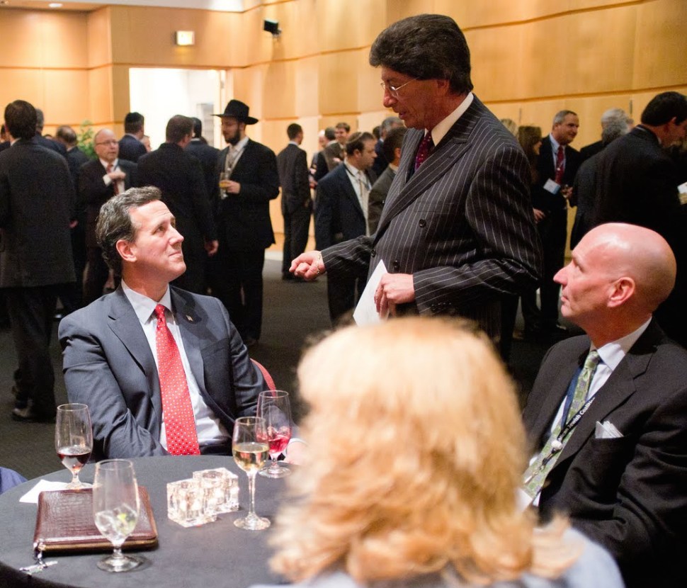 Presidential candidate Rick Santorum and GOP operative Michael Glassner talk to some guy with great hair and a pinstripe suit at the Republican Jewish Coalition meeting in Washington DC in 2012.