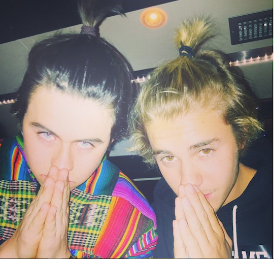 Justin Bieber rocked a ponytail in this Instagram picture that he posted in this Spring at Coachella with the caption “#ponytails.” (Photo: Courtesy of Justin Bieber’s Instagram)
