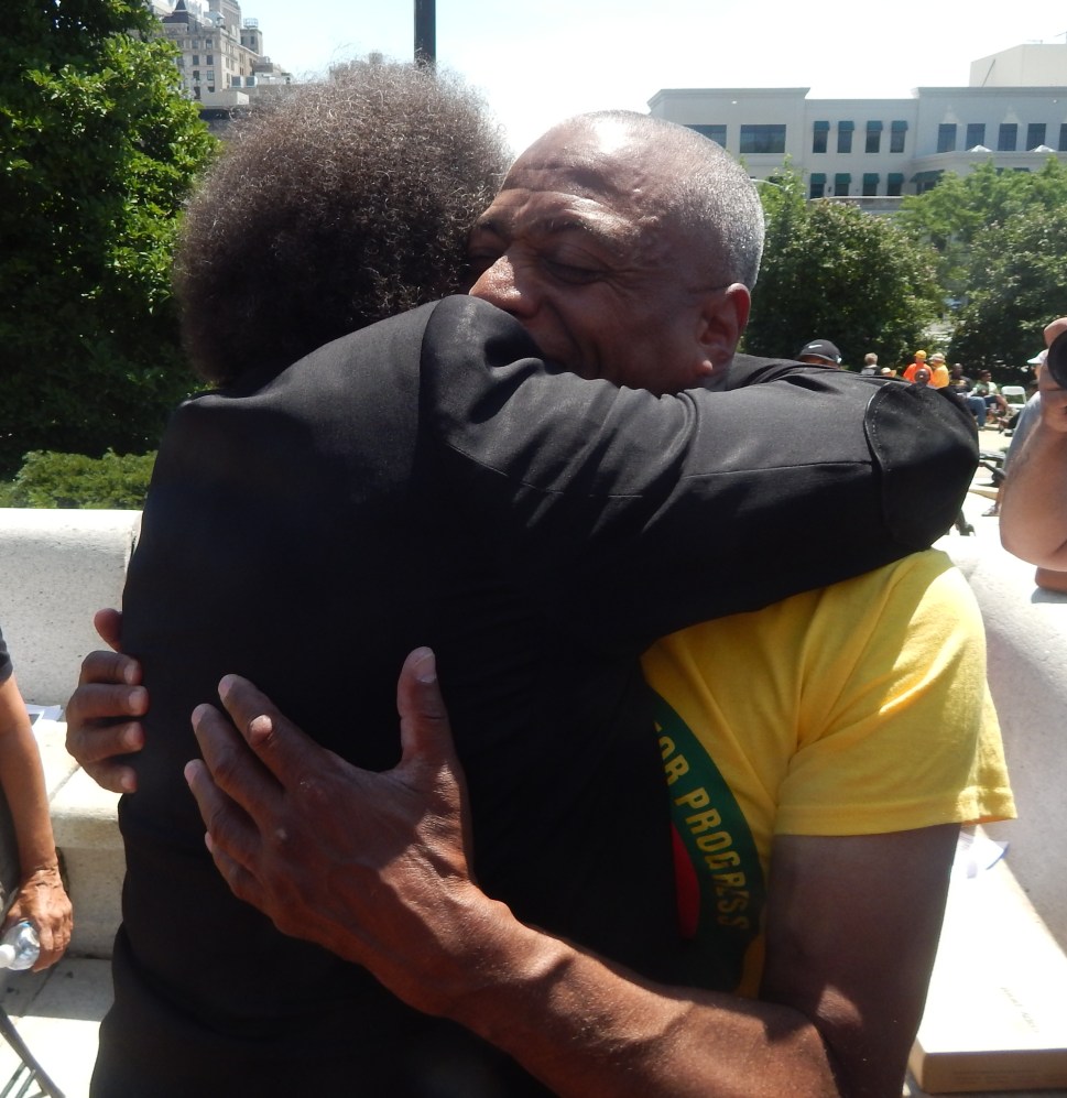 Princeton alumni philosopher Cornell West, left and Hamm, embrace on the steps of the Essex County Courthouse last year. A longtime Hamm ally, West is already on record in support of Sanders. 