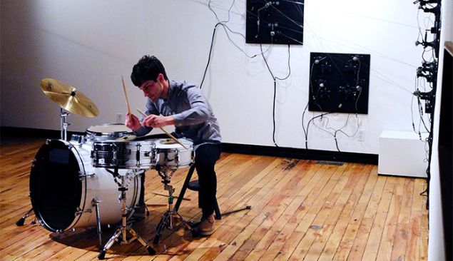 Eli performing on drums.