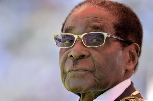 Zimbabwean President Robert Mugabe looks on during his inauguration and swearing-in ceremony on August 22, 2013 at the 60,000-seater sports stadium in Harare. Veteran Zimbabwean President Robert Mugabe was sworn in as Zimbabwe's president for another five-year term before a stadium packed with tens of thousands of jubilant supporters. AFP PHOTO / ALEXANDER JOE        (Photo credit should read ALEXANDER JOE/AFP/Getty Images)