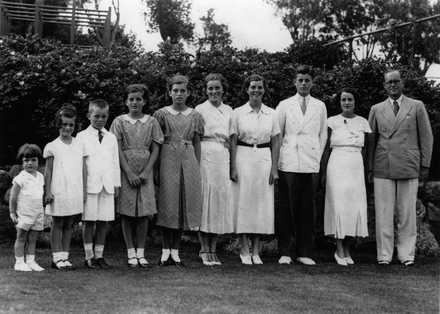 1937: American multi-millionaire Joseph Patrick Kennedy (right), the newly-appointed ambassador to London, with his wife Rose Kennedy (second from right) and eight of their nine children, in London. From left: Edward, Jeanne, Robert, Patricia (1924 - 2006), Eunice, Kathleen, Rosemary and John F Kennedy who later became the 35th President of the United States. (Photo by Keystone/Getty Images)