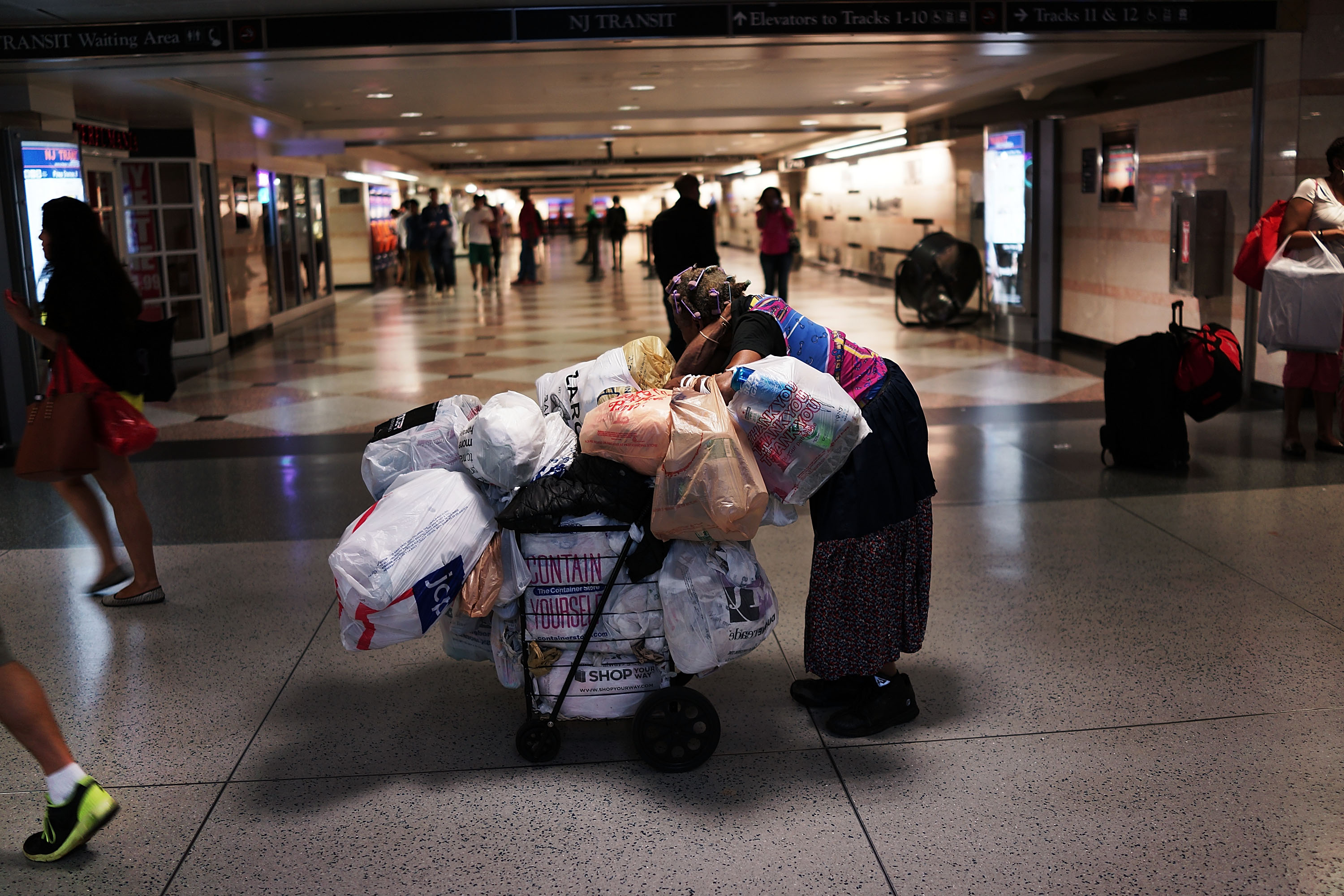 A homeless woman pauses in a Manhattan train station.