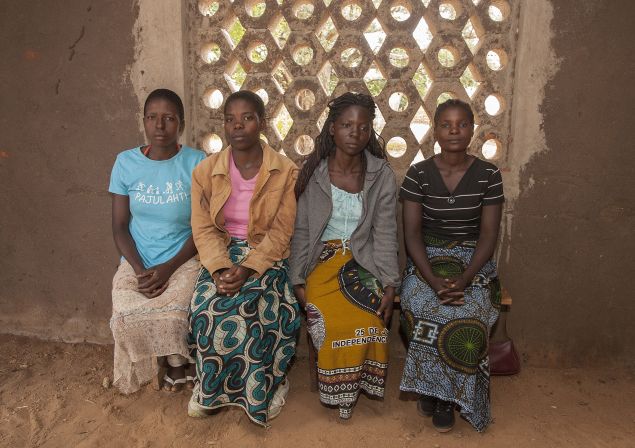 Sitting from left: Yvone Kambiza, 16, Alinafe Naison, 19, Catherine Julio Funsani, 21, and Katrina Kampingo, 15, who were underage brides sit on March 7, 2015 inside a hall at the Gender Equality and Women Empowerment (GEWE), a local organization whose objective is to fight early marriages and teenage pregnancies at the Mponela Trading Center in the area of Traditional Authority Mponela in Dowa District, some 70 kms north of the capital Lilongwe. Kambiza and Naison have since returned to school. Malawi is poised to adopt a law banning child marriages in a country which has one of the world's highest rates of under-age weddings. AFP PHOTO / AMOS GUMULIRA (Photo credit should read AMOS GUMULIRA/AFP/Getty Images)