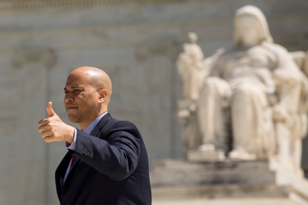 WASHINGTON, DC - APRIL 28: Sen. Cory Booker (D-NJ), gives the thumbs up to the crowd as he exits the Supreme Court after oral arguments were completed in the Obergefell v. Hodges case, April 28, 2015 in Washington, DC. On Tuesday the Supreme Court heard arguments concerning whether same-sex marriage is a constitutional right, with decisions expected in June. (Photo by Drew Angerer/Getty Images)