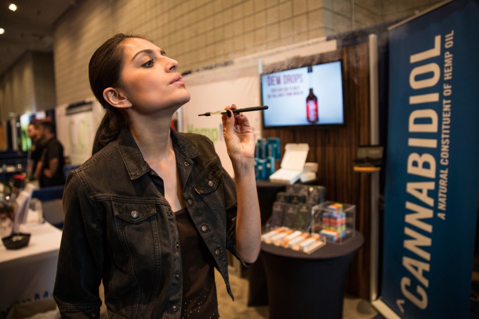 NEW YORK, NY - JUNE 19:  A woman poses while smoking a vape stick at the Cannabis World Congress Expo on June 19, 2015 in New York City.  Marijuana consumption is growing into a multimillion dollar industry as marijuana use - both recreational and medicinal- becomes legal in more U.S. states and more socially accepted.  (Photo by Andrew Burton/Getty Images)