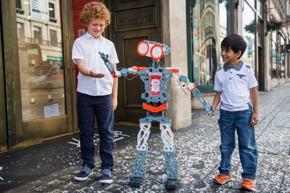 LONDON, ENGLAND - JUNE 25: Freddie, 9, and Miraan Jawed, 5, play with a 'Meccanoid G15 KS' robot outside Hamleys on Regent Street on June 25, 2015 in London, England. The robot, which is pre-programmed with over 1000 phrases and responds to voice commands, sells for £440. The Hamleys toy shop have made their predictions for the top selling toys for Christmas 2015. (Photo by Rob Stothard/Getty Images)