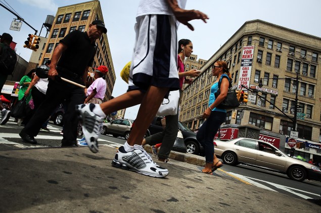 NEW YORK, NY - AUGUST 06:  People walk in an area of the Bronx which is the center of the outbreak Legionnaires disease on August 6, 2015 in New York City. It is believed that cooling towers in the area contributed to the illness which is believed to be contracted by inhaling mists from contaminated bacteria in the water source. The Bronx, and specifically the area around the Opera Hotel on East 149th Street, is in the middle of the largest outbreak of Legionnaires disease in New York City's history. New York authorities announced that as of Wednesday night the illness has now sickened nearly 100 people since July 10, with at least eight people having died.  (Photo by Spencer Platt/Getty Images)