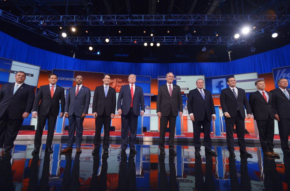 Republican presidential candidates arrive on stage for the Republican presidential debate on August 6, 2015 at the Quicken Loans Arena in Cleveland, Ohio. From left are: New Jersey Gov. Chris Christie; Florida Sen. Marco Rubio; retired neurosurgeon Ben Carson; Wisconsin Gov. Scott Walker; real estate magnate Donald Trump; former Florida Gov. Jeb Bush; former Arkansas Gov. Mike Huckabee; Texas Sen. Ted Cruz; Kentucky Sen. Rand Paul; and Ohio Gov. John Kasich. AFP PHOTO / MANDEL NGAN (Photo credit should read MANDEL NGAN/AFP/Getty Images)