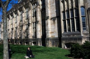NEW HAVEN, CT - APRIL 15: A woman sits on the grass on the campus of Yale University April 15, 2008 in New Haven, Connecticut. New Haven boasts many educational and cultural offerings that attract visitors to the city. (Photo by Christopher Capozziello/Getty Images)