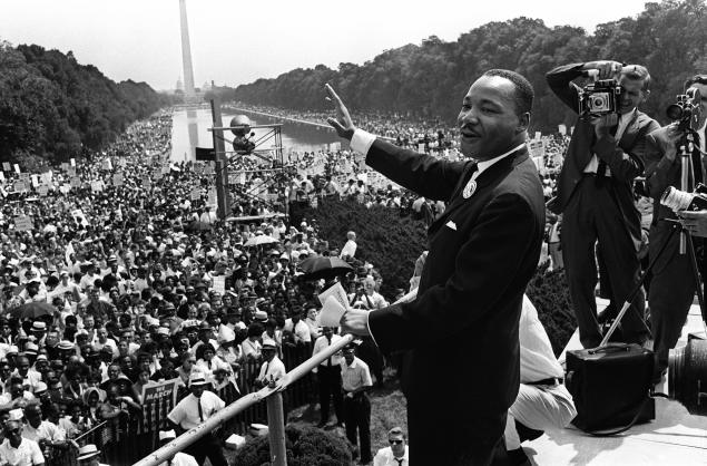 The civil rights leader Martin Luther KIng (C) waves to supporters 28 August 1963 on the Mall in Washington DC (Washington Monument in background) during the "March on Washington". King said the march was "the greatest demonstration of freedom in the history of the United States." Martin Luther King was assassinated on 04 April 1968 in Memphis, Tennessee. James Earl Ray confessed to shooting King and was sentenced to 99 years in prison. King's killing sent shock waves through American society at the time, and is still regarded as a landmark event in recent US history. AFP PHOTO (Photo credit should read -/AFP/Getty Images)