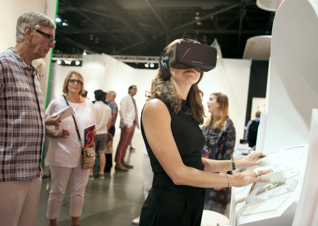 A visitor tries Micah Ganske's Ocular EVA Pod at Los Angeles gallery 101/Exhibit's booth. (Photo: Seattle Art Fair)