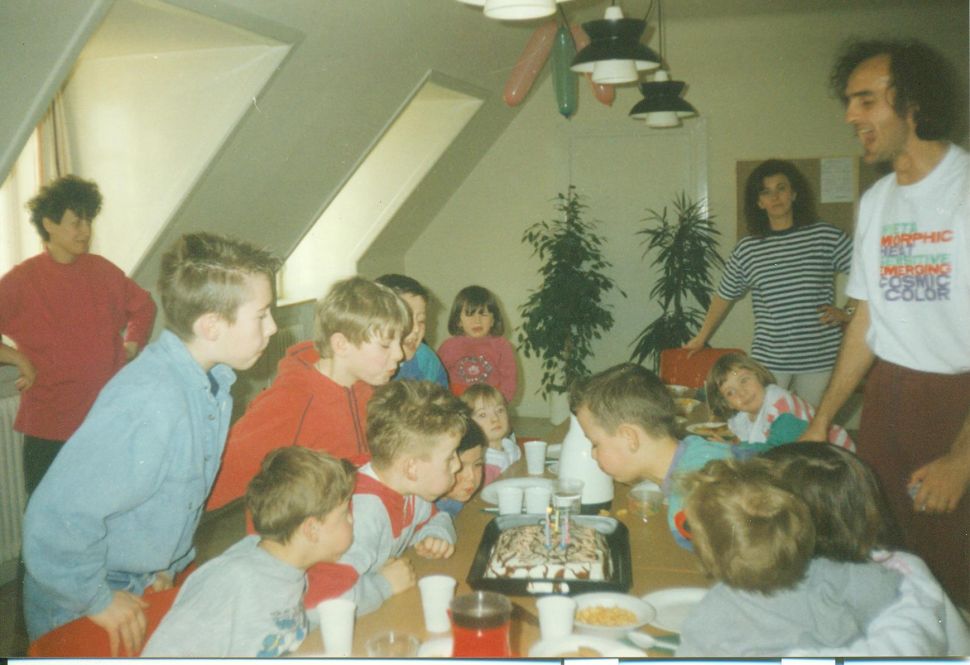 The author blowing out five candles on his birthday cake at a refugee center in Denmark. (Courtesy Arman Dzidzovic)